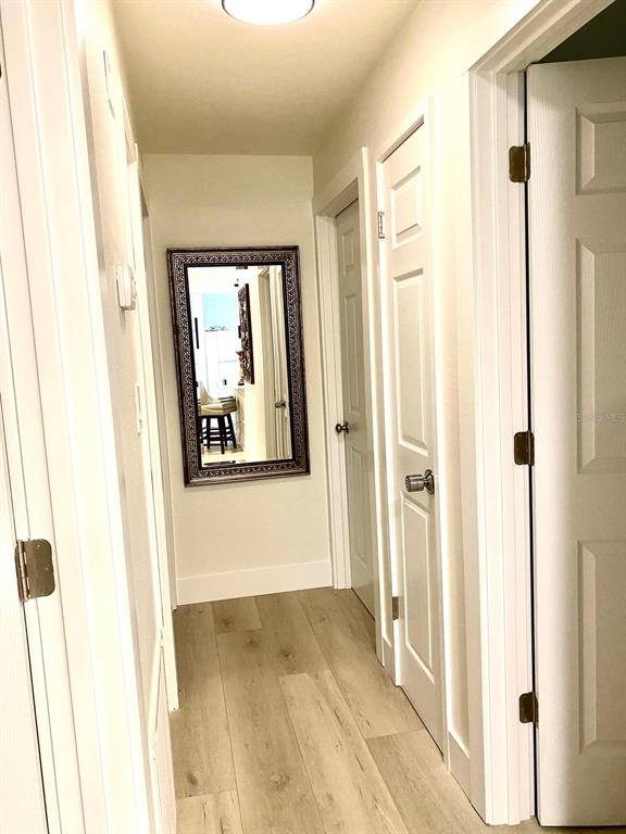415 Mapleway, Unit A Safety Harbor, FL 34695 - Photo 24 of 50 a view of a hallway with wooden floor and closet