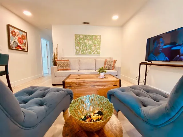 a living room with furniture a rug and a large window