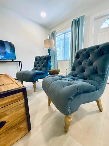 a large bed sitting in a bedroom next to a window