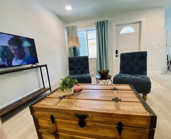 a living room with furniture and wooden floor