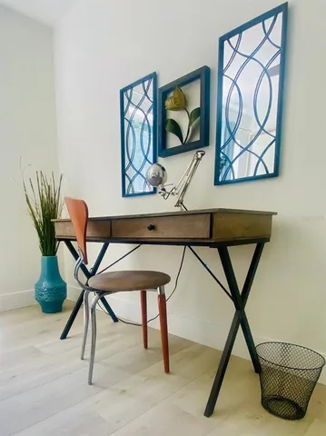 a work room with furniture and a potted plant