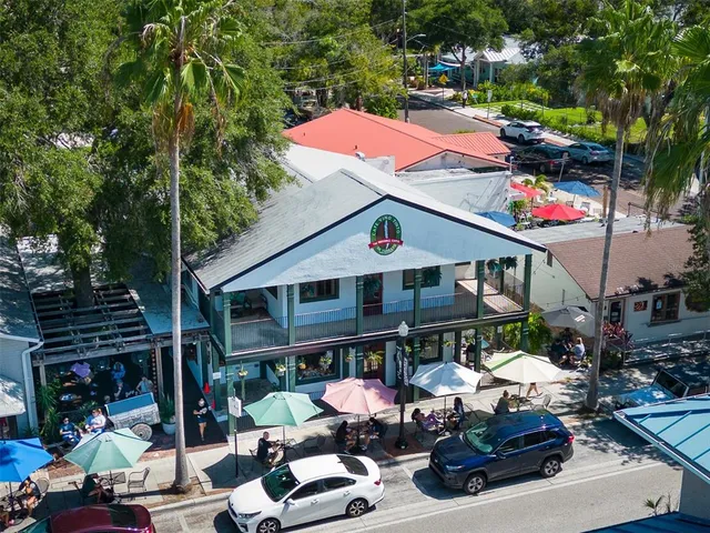 an aerial view of a house with a yard