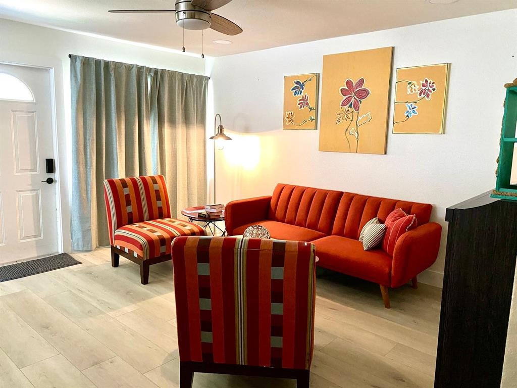 415 Mapleway, Unit A Safety Harbor, FL 34695 - Photo 9 of 50 a living room with furniture a couch and a flat screen tv