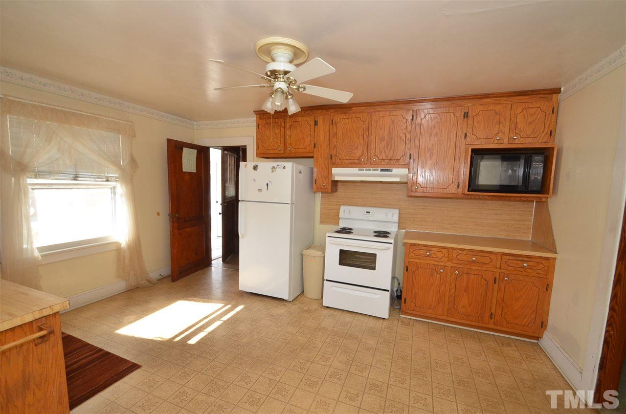 1003 Junction Road Durham, NC 27704 - Photo 4 of 19 a kitchen with a refrigerator and microwave