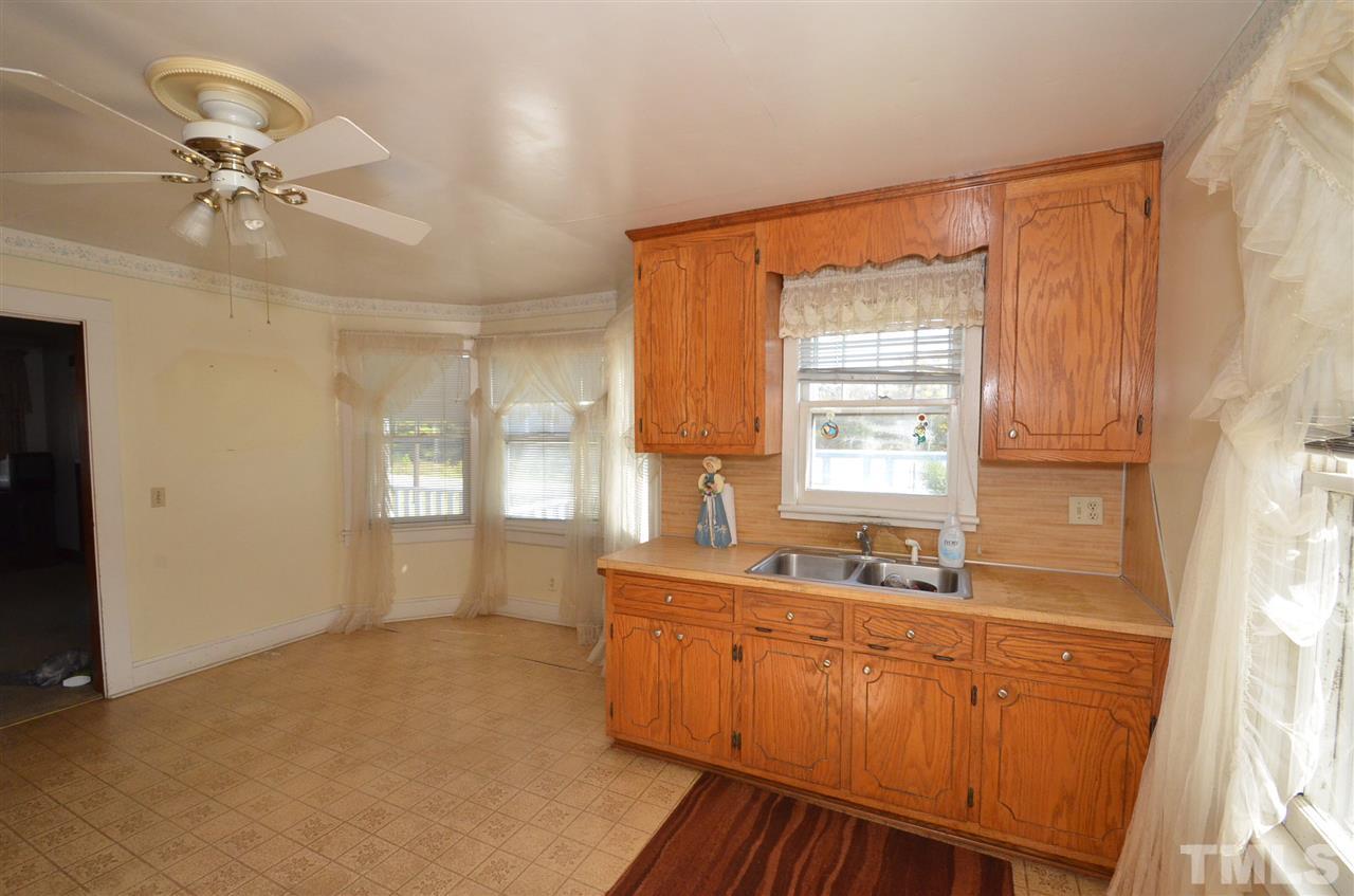 1003 Junction Road Durham, NC 27704 - Photo 5 of 19 a spacious bathroom with a double vanity sink a mirror and a bathtub