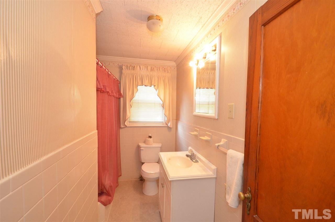 1003 Junction Road Durham, NC 27704 - Photo 7 of 19 a bathroom with a toilet sink and mirror