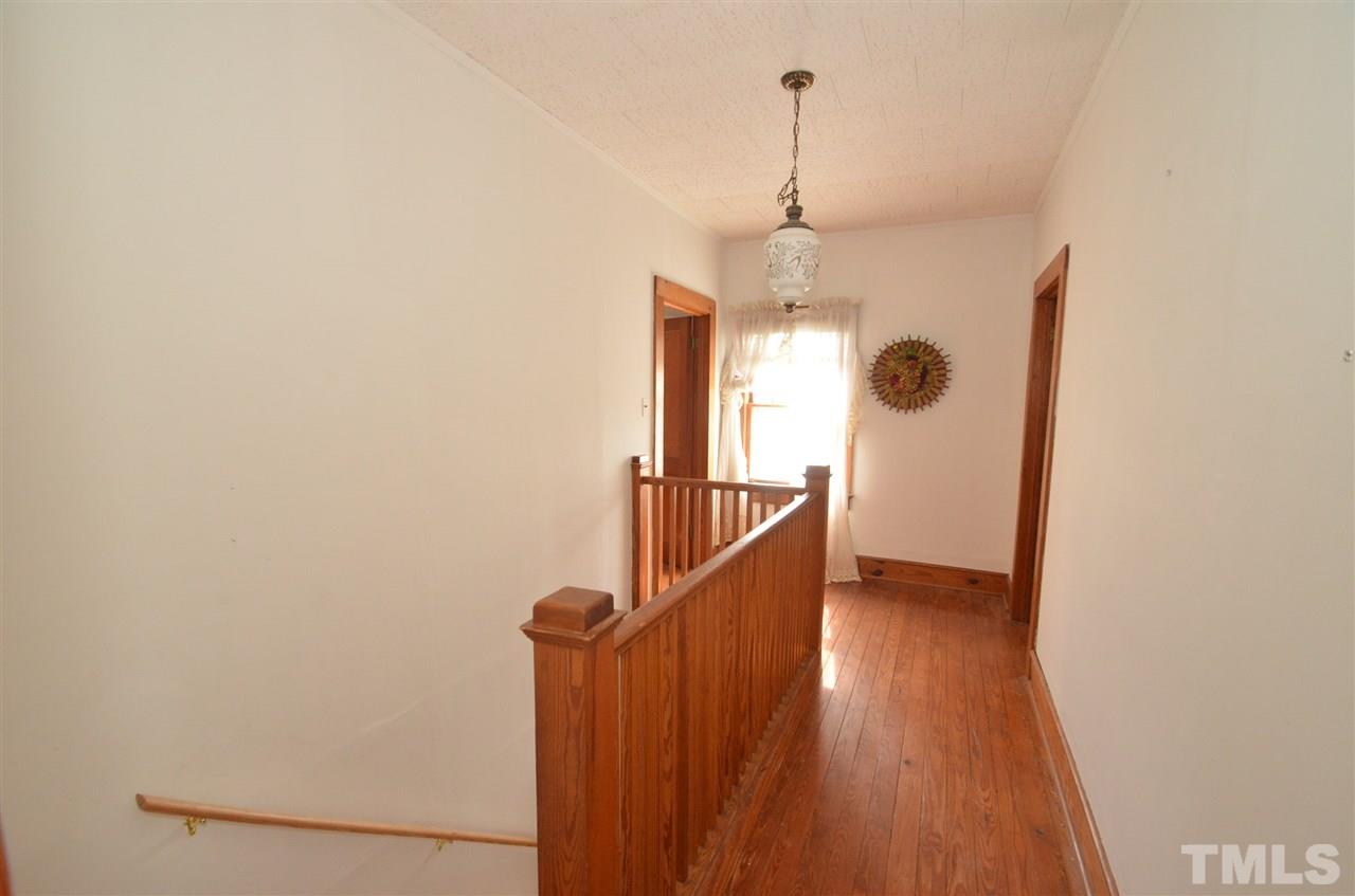 1003 Junction Road Durham, NC 27704 - Photo 8 of 19 a view of a hallway with wooden floor and staircase