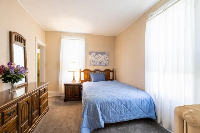 a bedroom with a bed and a potted plant