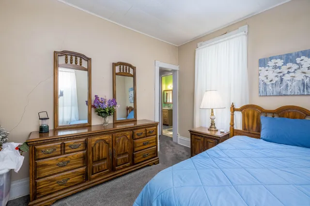 a bathroom with a sink mirror and window