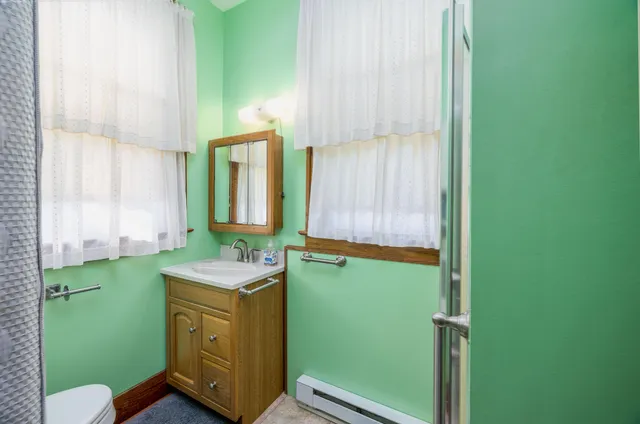 a bathroom with a shower and a mirror