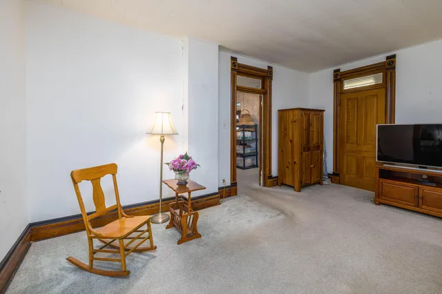 a view of a livingroom with furniture and a bedroom