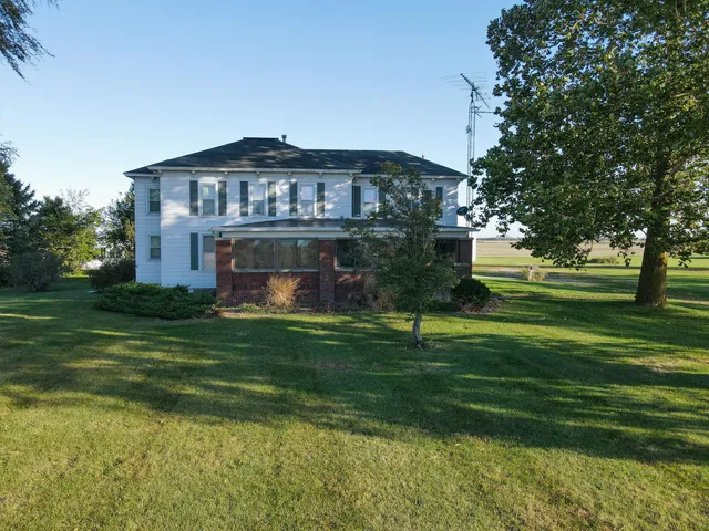 a front view of house with yard and trees