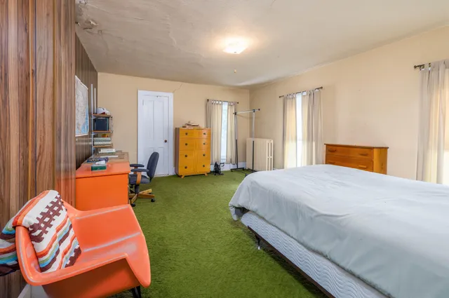 a bedroom with furniture and a window