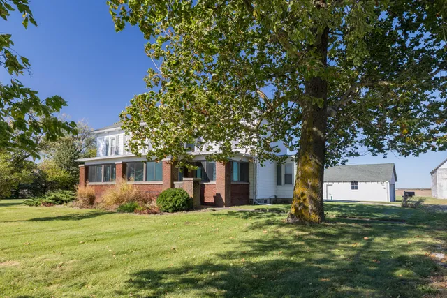a kitchen with stainless steel appliances kitchen island granite countertop a table and chairs in it