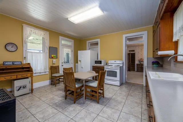 a kitchen with stainless steel appliances granite countertop a stove a sink dishwasher and a refrigerator