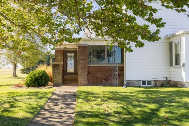 a view of a big house with a big yard