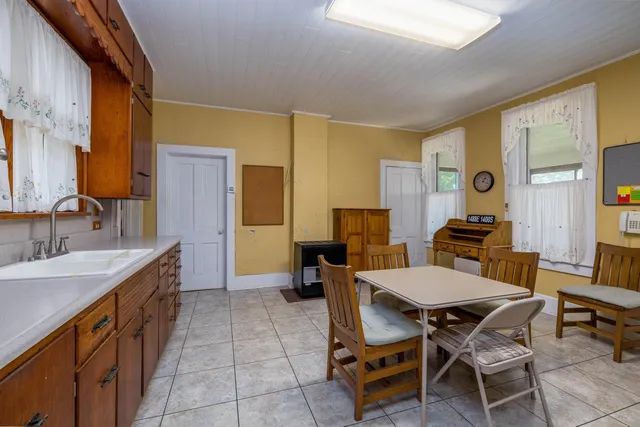 a view of a dining room with furniture and chandelier