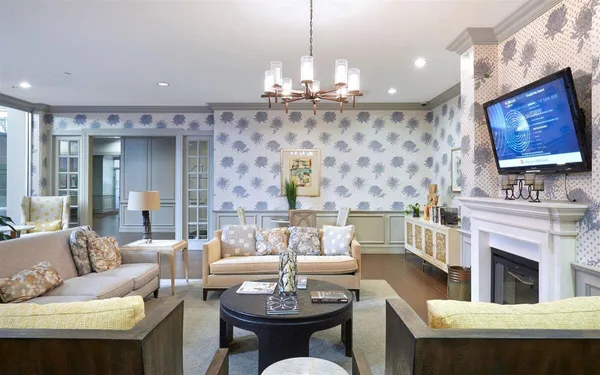 a living room with fireplace furniture and a chandelier