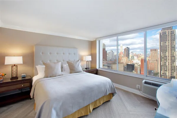 a bedroom with a large bed and a large window