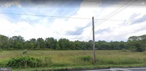 a view of a green field with a fence