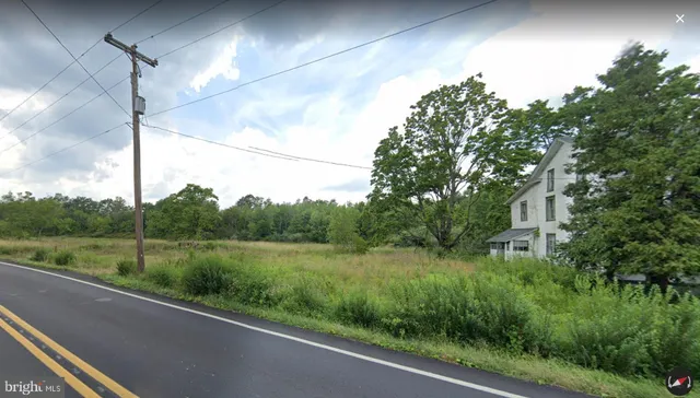a view of a yard and mountain view