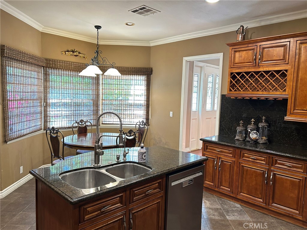 300 South Timken Road Anaheim, CA 92808 - Photo 17 of 40 a kitchen with granite countertop a sink and a wooden floor