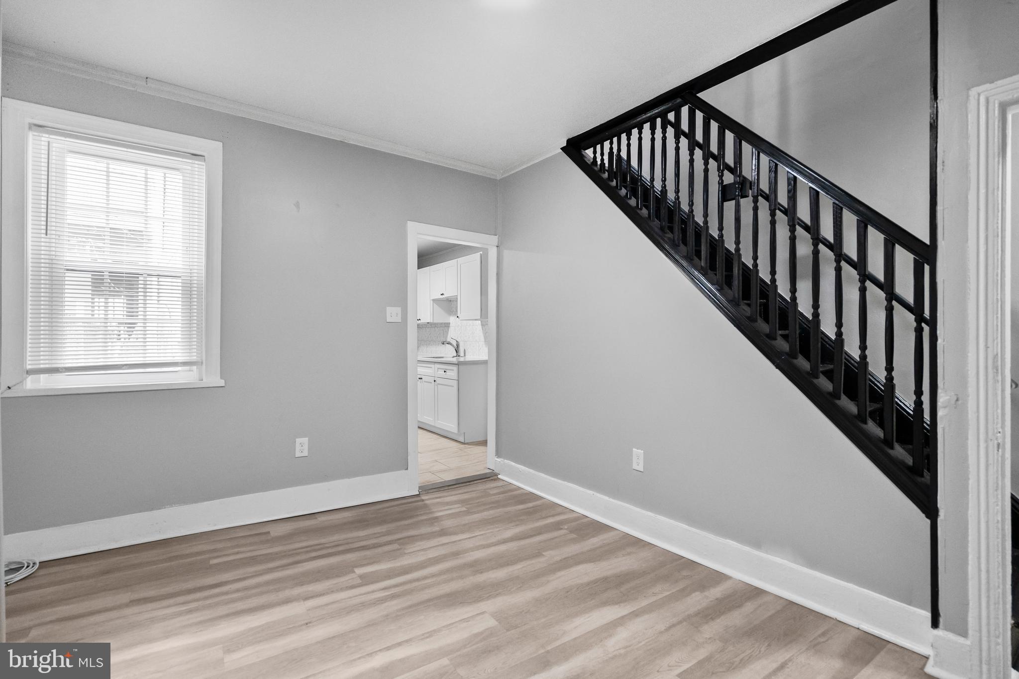 3856 Olive Street Philadelphia, PA 19104 - Photo 2 of 7 a view of an empty room with wooden floor and stairs