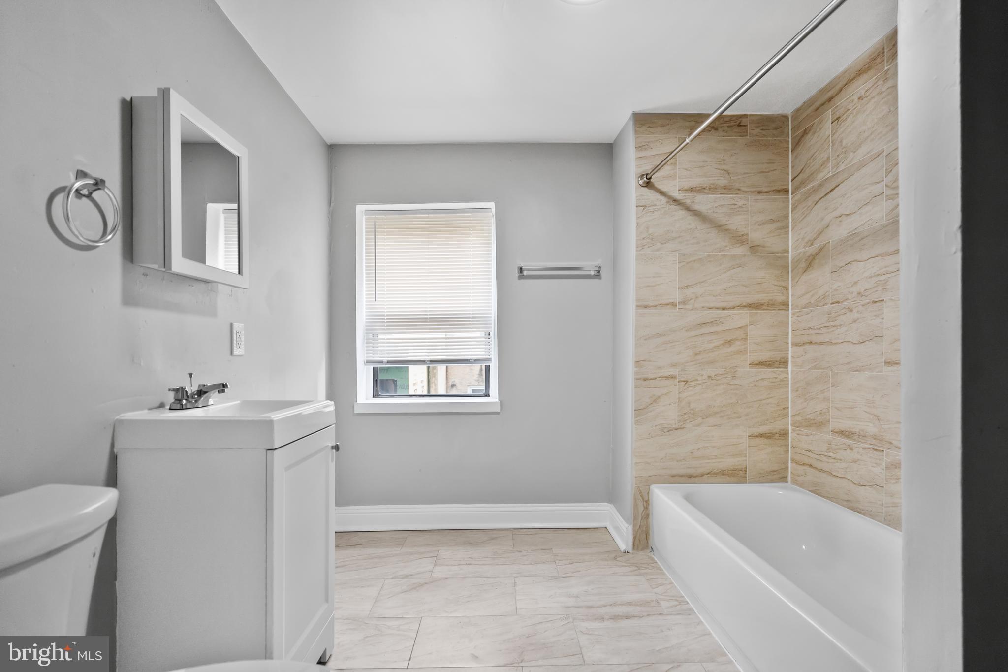 3856 Olive Street Philadelphia, PA 19104 - Photo 4 of 7 a bathroom with a bathtub a toilet a sink and shower