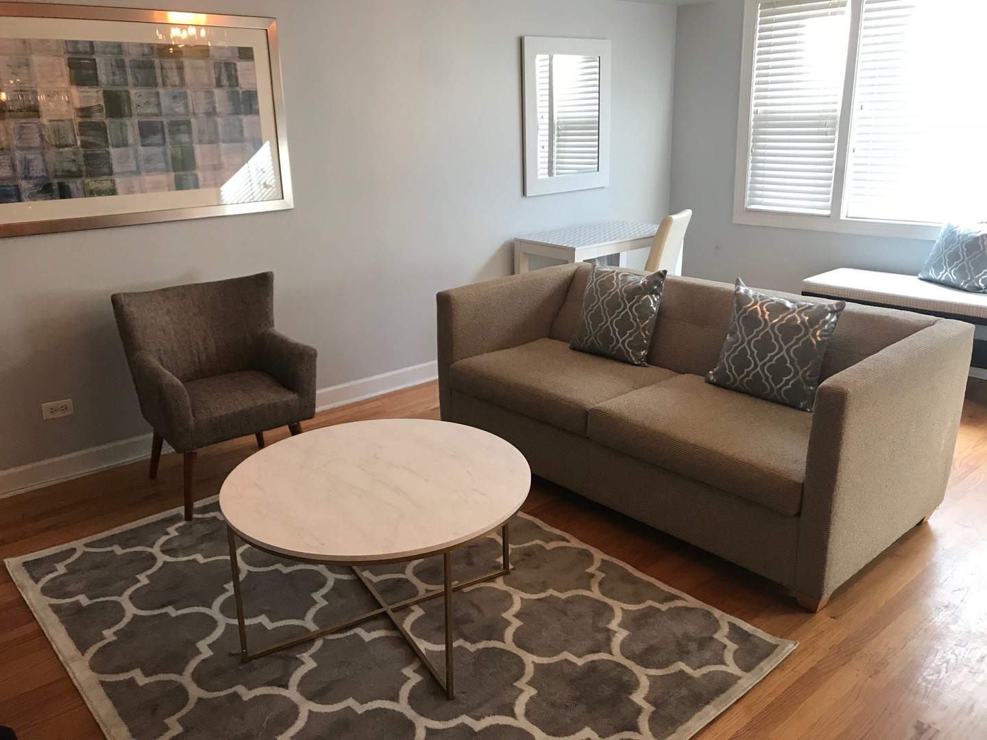 1223 North Cleaver Street, Unit 2 Chicago, IL 60642 - Photo 2 of 7 a living room with a couch and windows