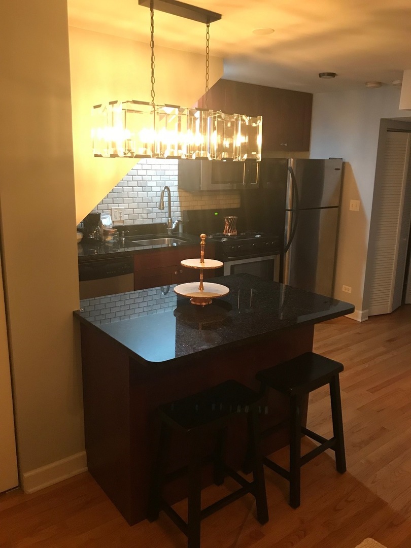 1223 North Cleaver Street, Unit 2 Chicago, IL 60642 - Photo 3 of 7 a dining room with furniture and window