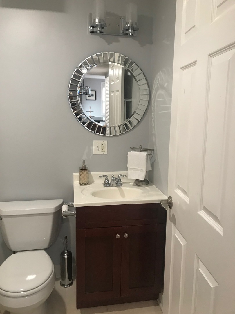 1223 North Cleaver Street, Unit 2 Chicago, IL 60642 - Photo 5 of 7 a bathroom with a toilet a sink and a mirror