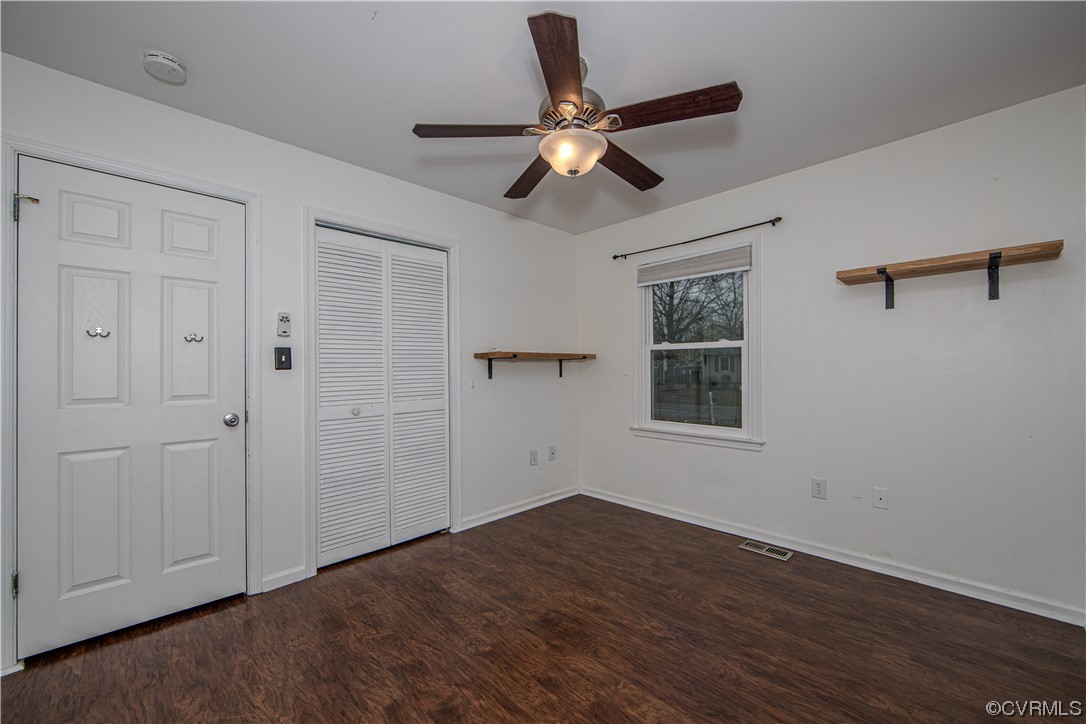 15909 Sandwave Road Chester, VA 23831 - Photo 7 of 20 a view of empty room with wooden floor and fan