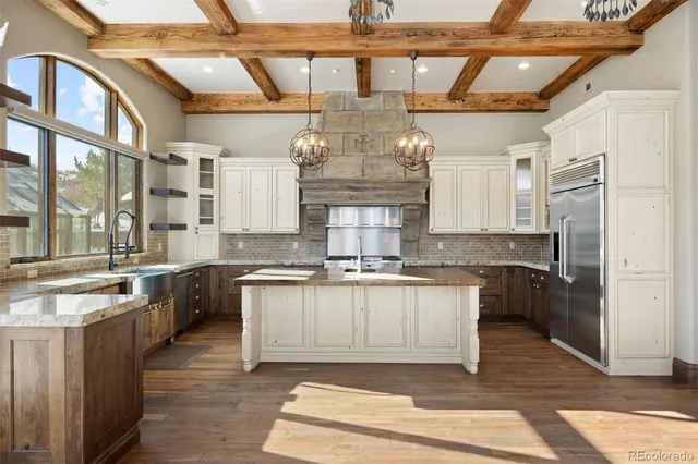 a kitchen with a sink cabinets and wooden floor