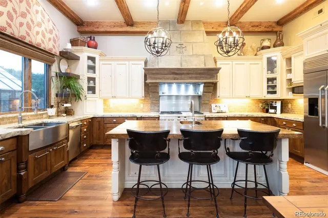 a large kitchen with a table and chairs