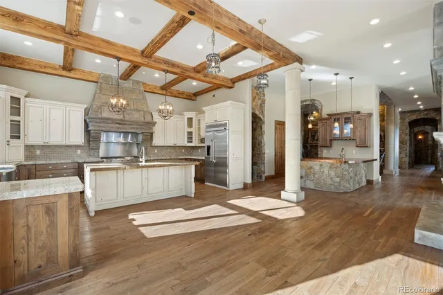 a large kitchen with cabinets and wooden floor