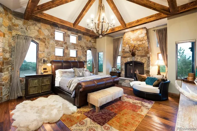 a bedroom with furniture fireplace and a large window