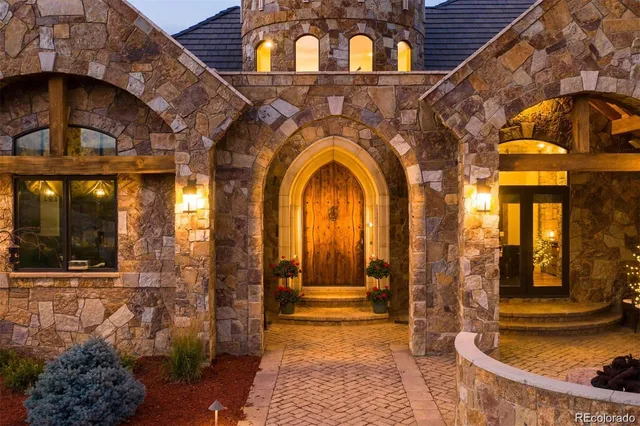 a view of a brick house with large windows