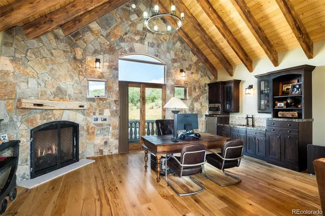 a dining room with furniture a fireplace and wooden floor
