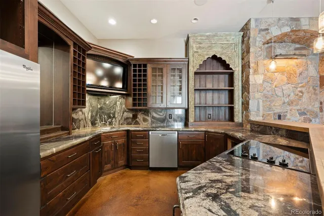 a kitchen with stainless steel appliances granite countertop a sink and a stove