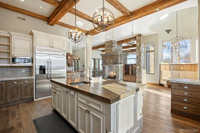 a kitchen with stainless steel appliances granite countertop a sink and cabinets