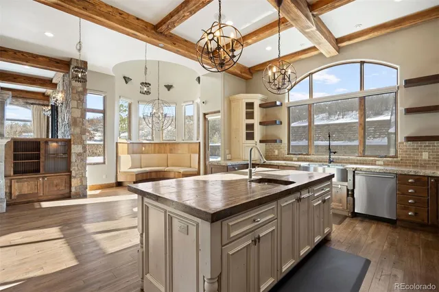 a kitchen with granite countertop a sink and cabinets