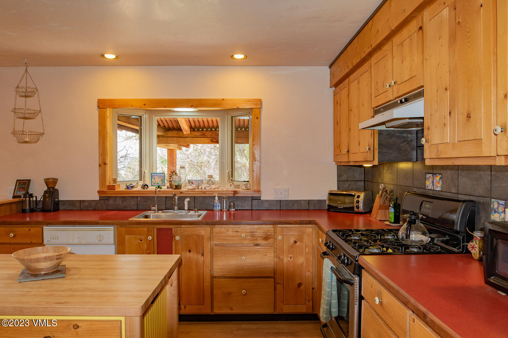 460 Mesa Drive Eagle, CO 81631 - Photo 11 of 42 a kitchen with stainless steel appliances granite countertop a stove a sink and a microwave