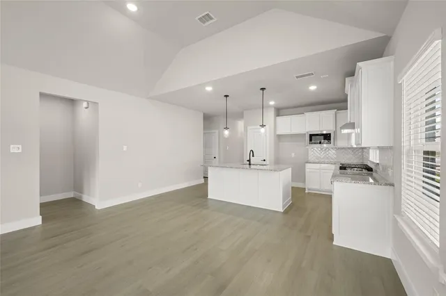 a view of a kitchen with a sink and a refrigerator