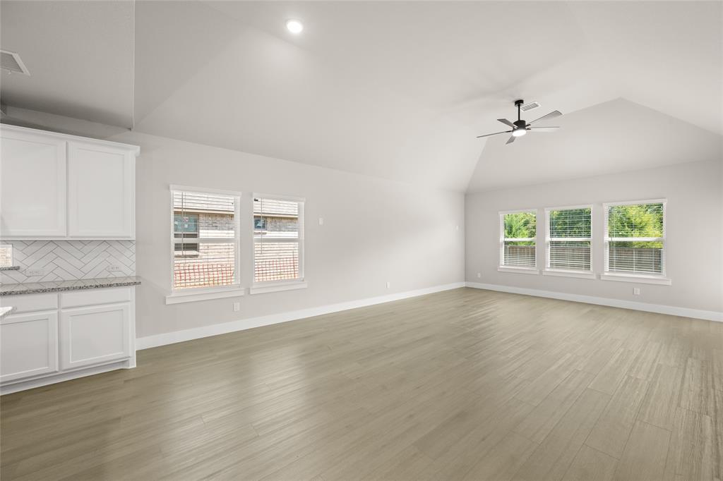 1850 Silver Birch Road Waxahachie, TX 75165 - Photo 16 of 36 wooden floor in an empty room with a window