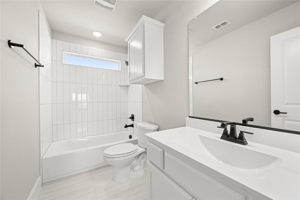 1850 Silver Birch Road Waxahachie, TX 75165 - Photo 30 of 36 a bathroom with a bathtub shower sink mirror and toilet