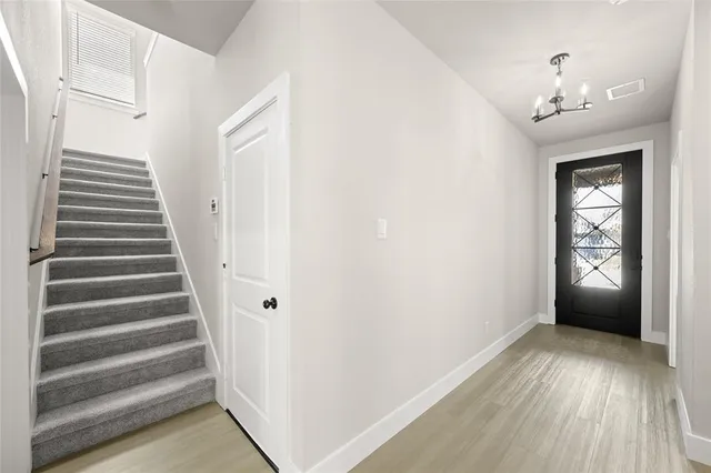 a view of an entryway with wooden floor