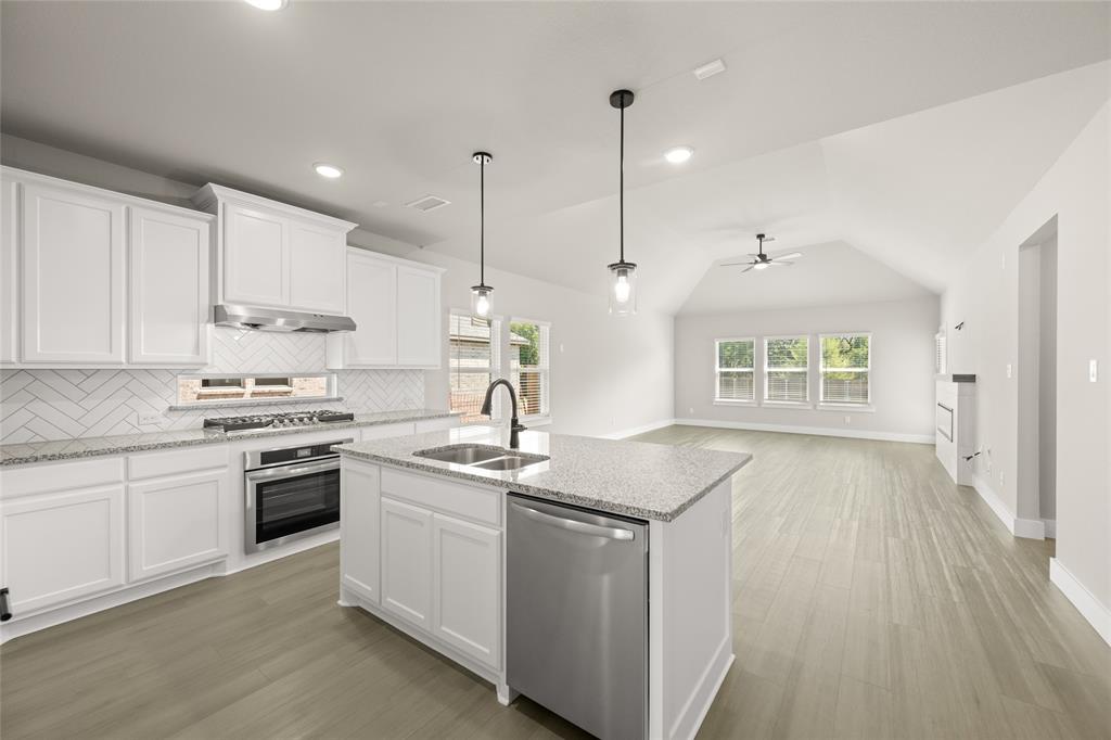 1850 Silver Birch Road Waxahachie, TX 75165 - Photo 6 of 36 a kitchen with a stove sink and cabinets