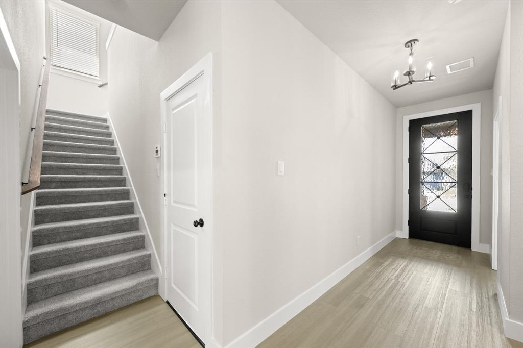 1850 Silver Birch Road Waxahachie, TX 75165 - Photo 7 of 36 a view of an entryway with wooden floor