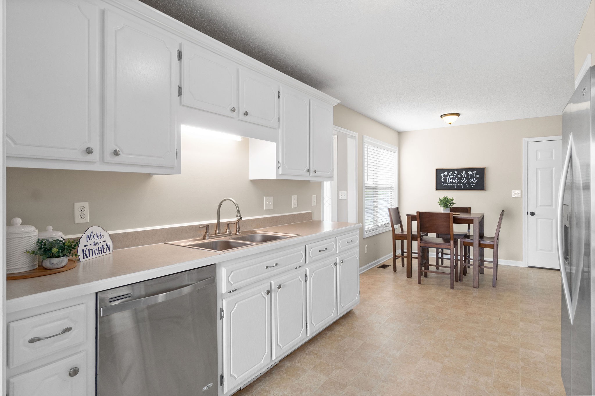 1626 Windriver Road Clarksville, TN 37042 - Photo 11 of 31 a kitchen with white cabinets sink and dining table
