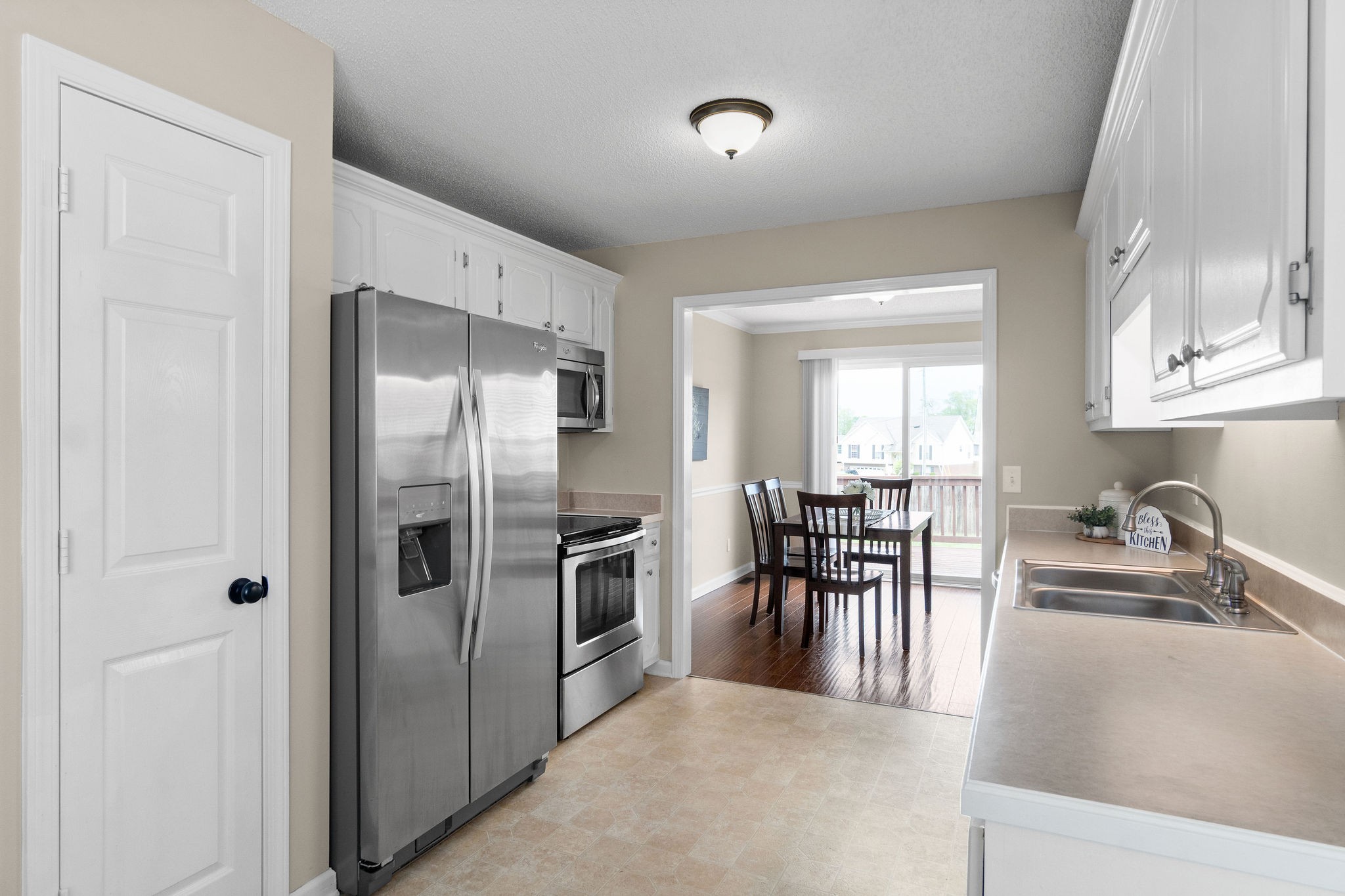 1626 Windriver Road Clarksville, TN 37042 - Photo 13 of 31 a kitchen with granite countertop a refrigerator and a sink